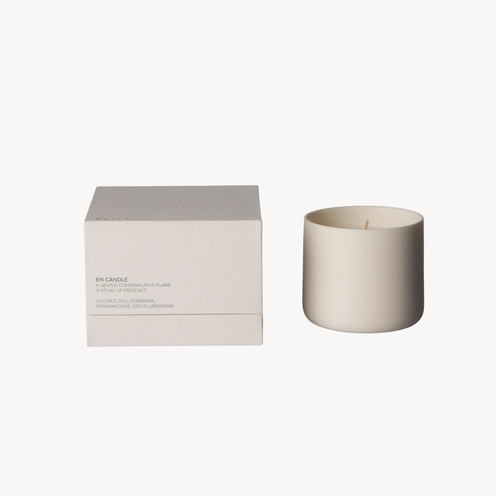 White candle and box on a white background