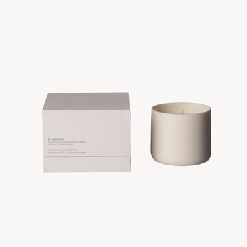 White candle and box on a white background